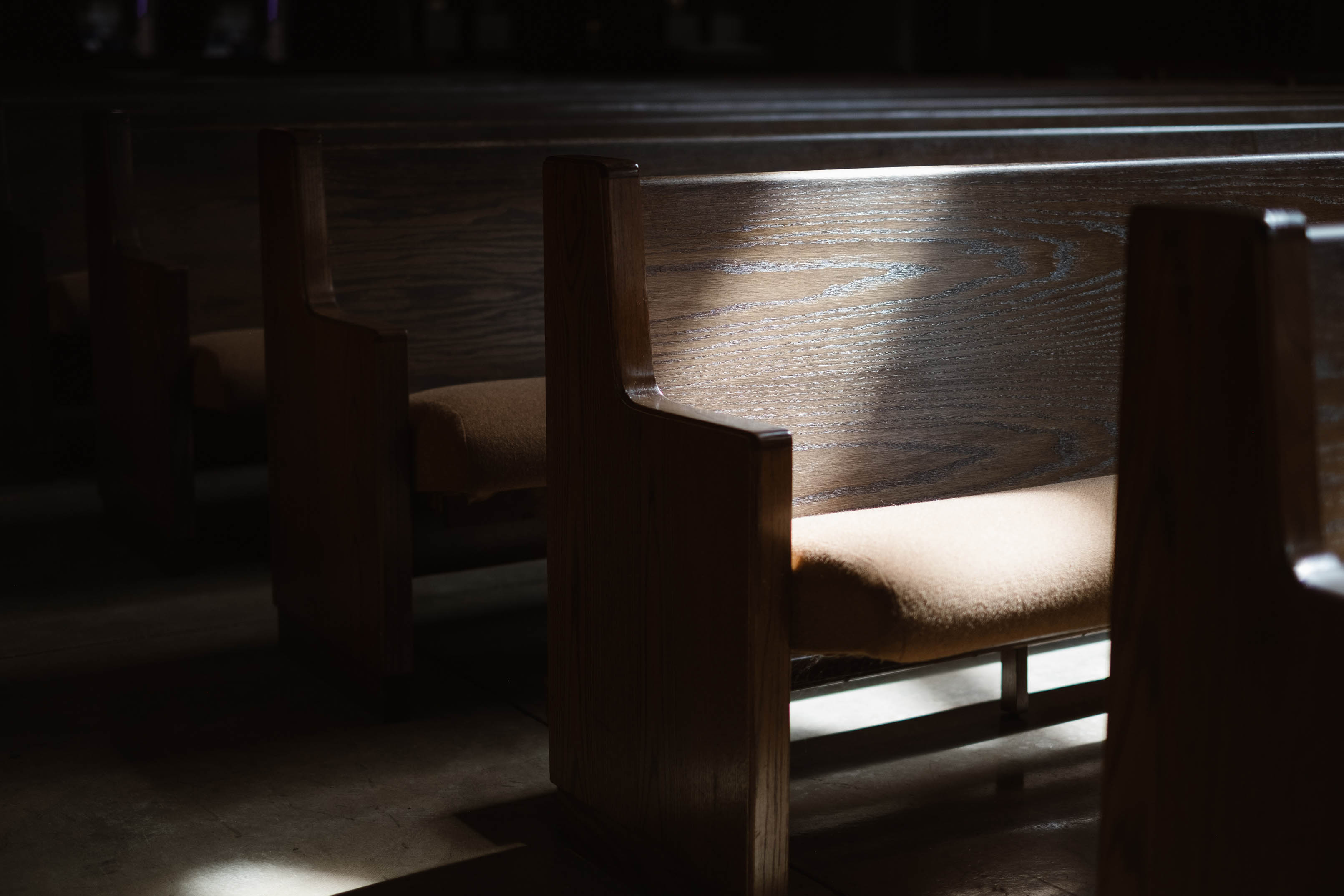 Wooden church pews with sunlight